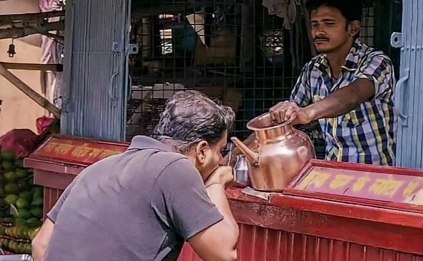 Daily News Reel - Shop Owner Feeding Water to Passers-by